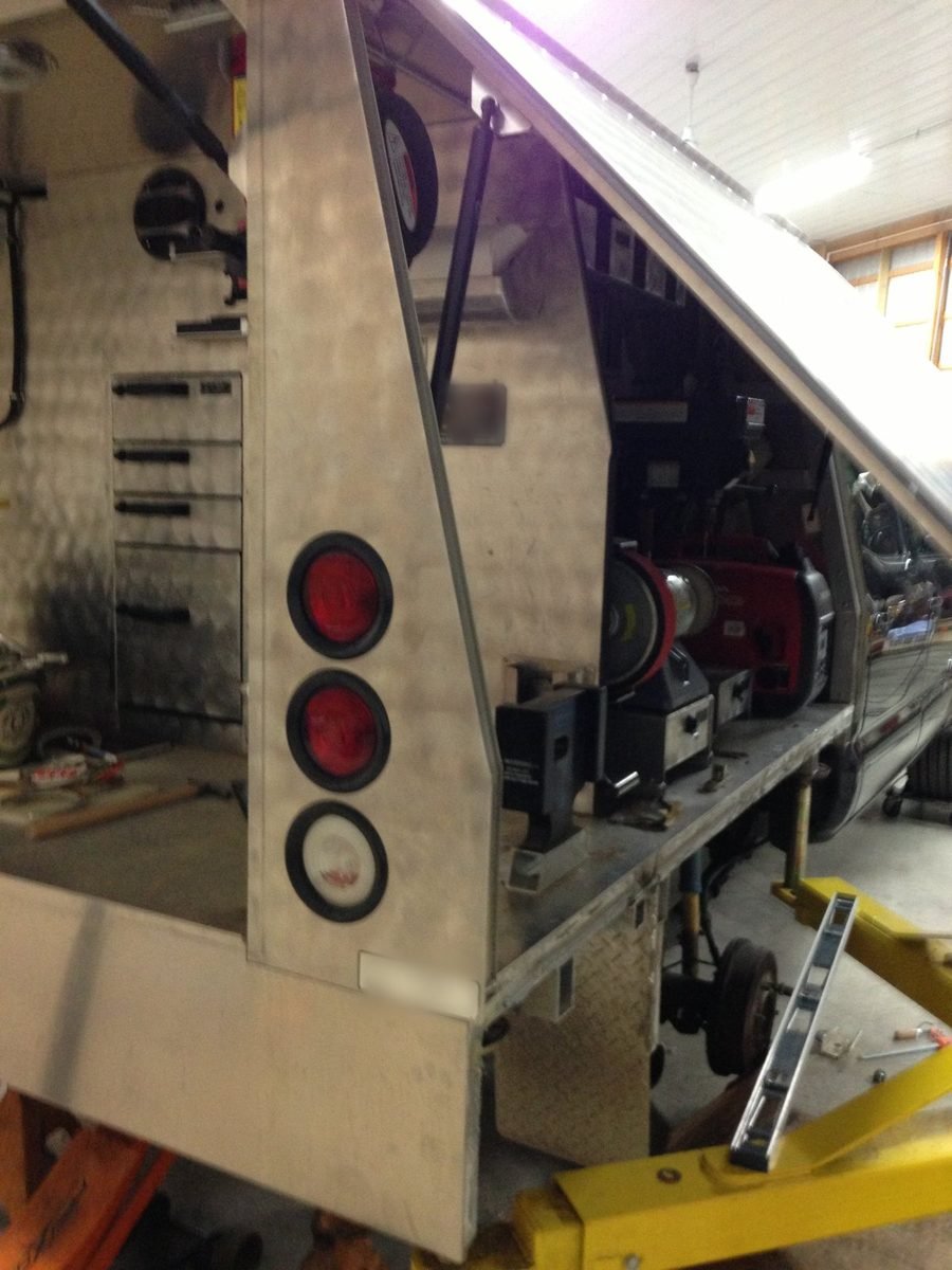 Aluminum truck service body with tool compartments in the shop for welding repair