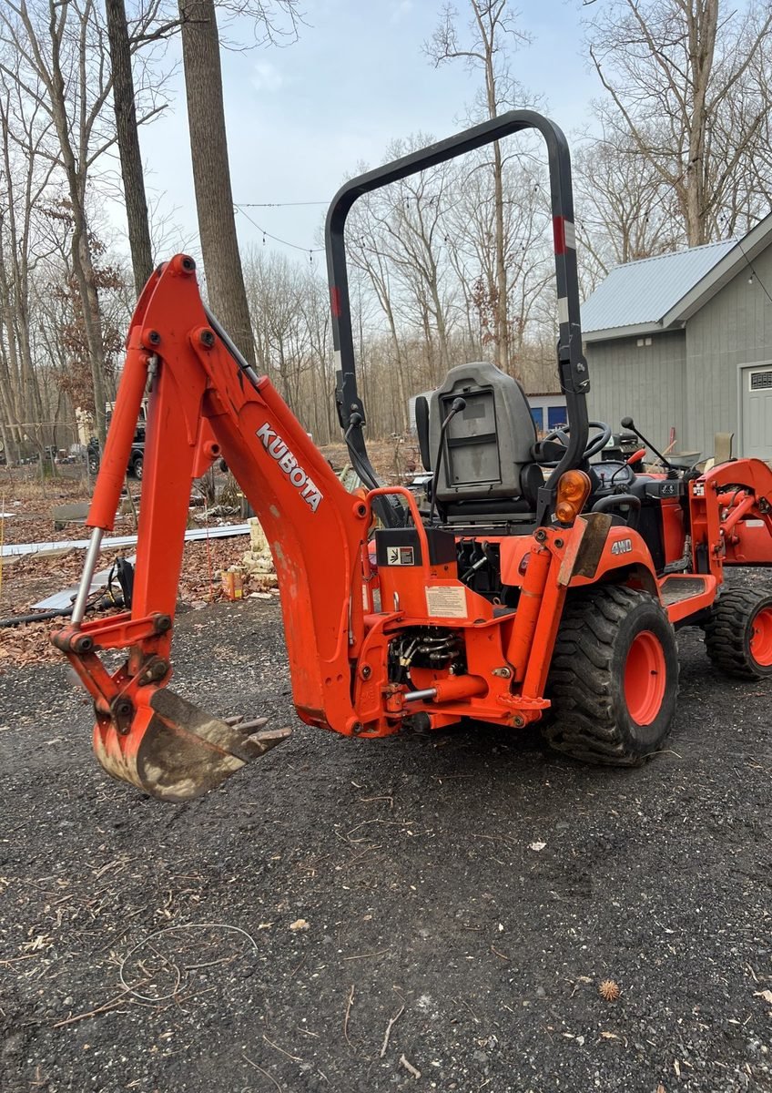 Kubota compact tractor with backhoe attachment in for welding repair